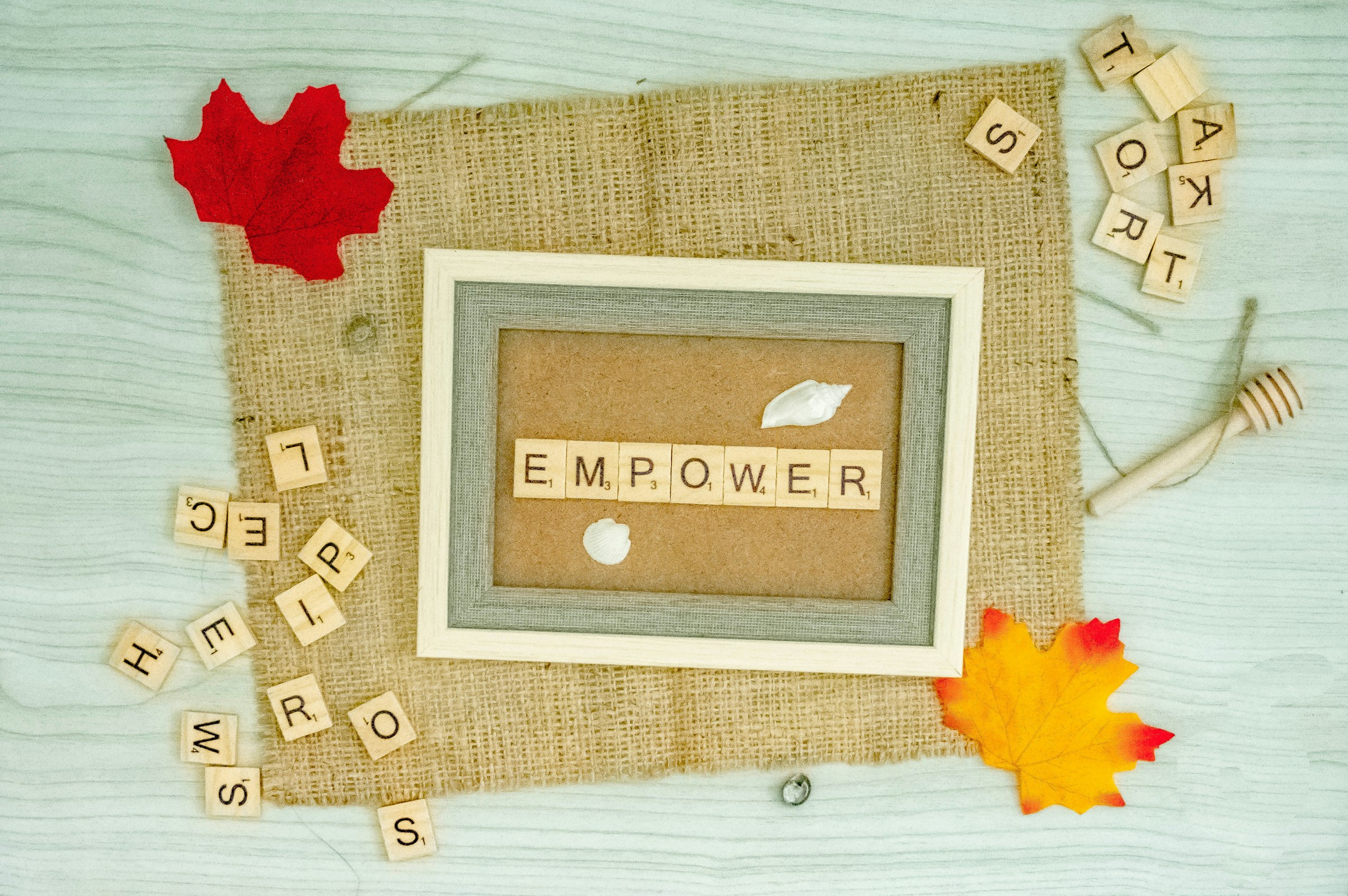 a picture frame with the word empower spelled in scrabble